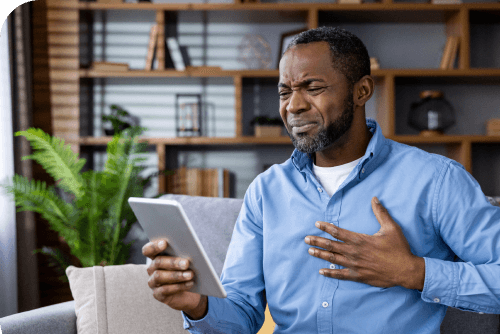 A man consulting a doctor on his tablet at home